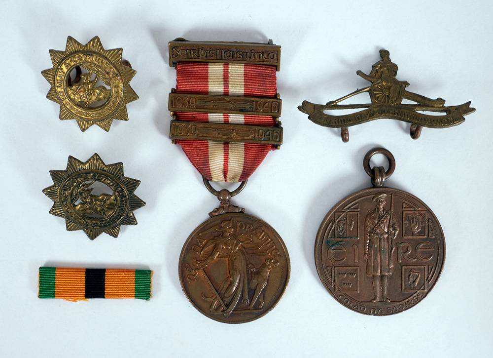 1917-1921  War of Independence Service Medal, 1939-46 Emergency Service Medal (Defence Forces) with two bars and badges. at Whyte's Auctions