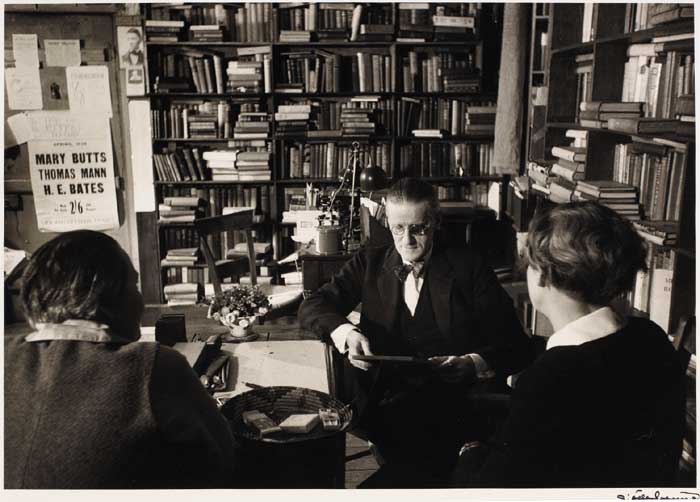 JAMES JOYCE WITH ADRIENNE MONNIER AND SYLVIA BEACH IN SHAKESPEARE AND CO. BOOKSHOP, MAY 1938 by Gis�le Freund (German, 1908-2000) at Whyte's Auctions