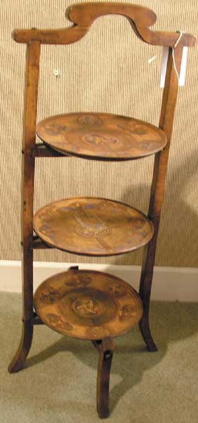 Circa 1900-1910 wooden Celtic Revival cake stand with motifs from illuminated manuscripts at Whyte's Auctions