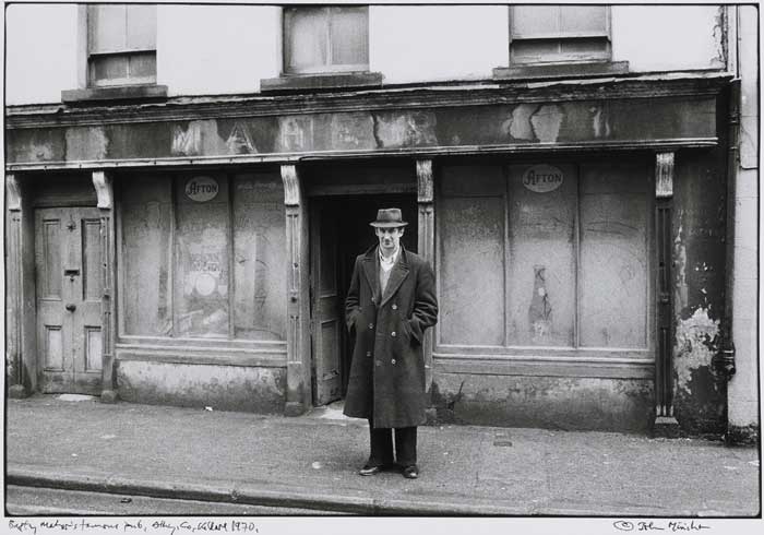 MAN OUTSIDE BAPTY MAHER'S FAMOUS PUB, ATHY, COUNTY KILDARE, 1970 by John Minihan (b.1946) at Whyte's Auctions