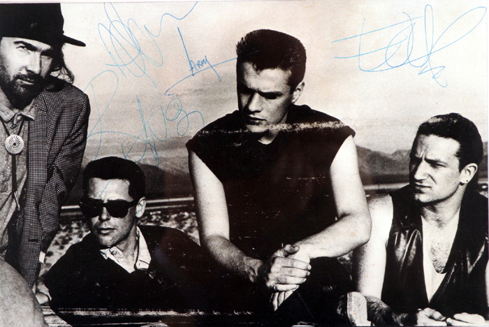 U2 photograph signed by all four band members. at Whyte's Auctions