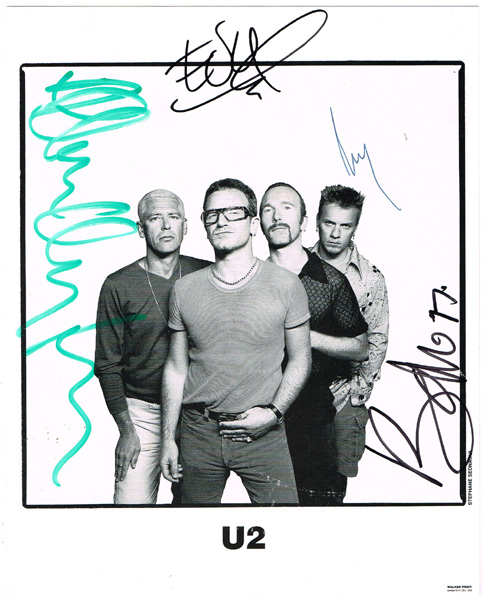 U2 Publicity photograph signed by all four members and a VIP badge for The Joshua Tree concert at Croke Park. at Whyte's Auctions