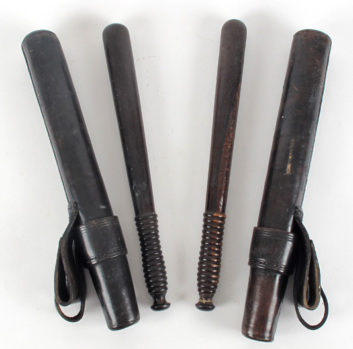 Two Police truncheons in leather uniform scabbards. at Whyte's Auctions