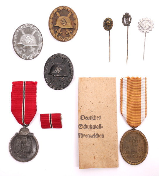 1939-1945 German Third Reich 1939 Pattern Gold, Silver and Black Wound Badges and Russian Front and West Wall Medals. at Whyte's Auctions