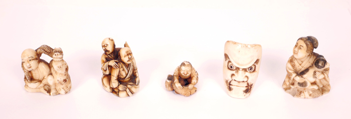 A collection of four Japanese carved ivory netsuke and a miniature mask. at Whyte's Auctions