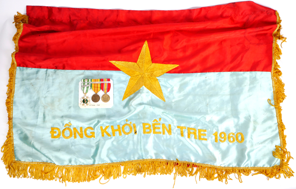 1975 Flag of Republic of South Vietnam, commemorating Dong Khoi Ben Tre 1960, and a group of three US medals. at Whyte's Auctions