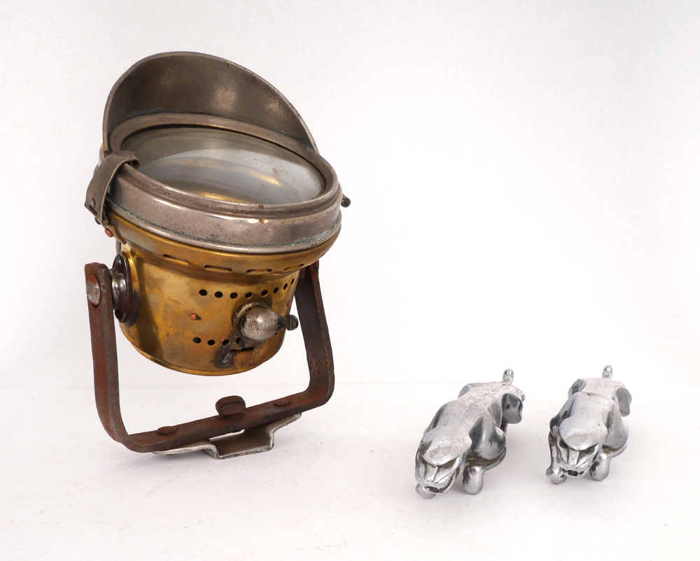 Two Jaguar mascots and a brass motorcycle headlight. at Whyte's Auctions