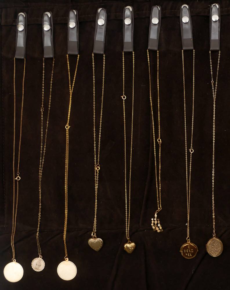 Sixteen various 9ct gold pendants on chains. at Whyte's Auctions