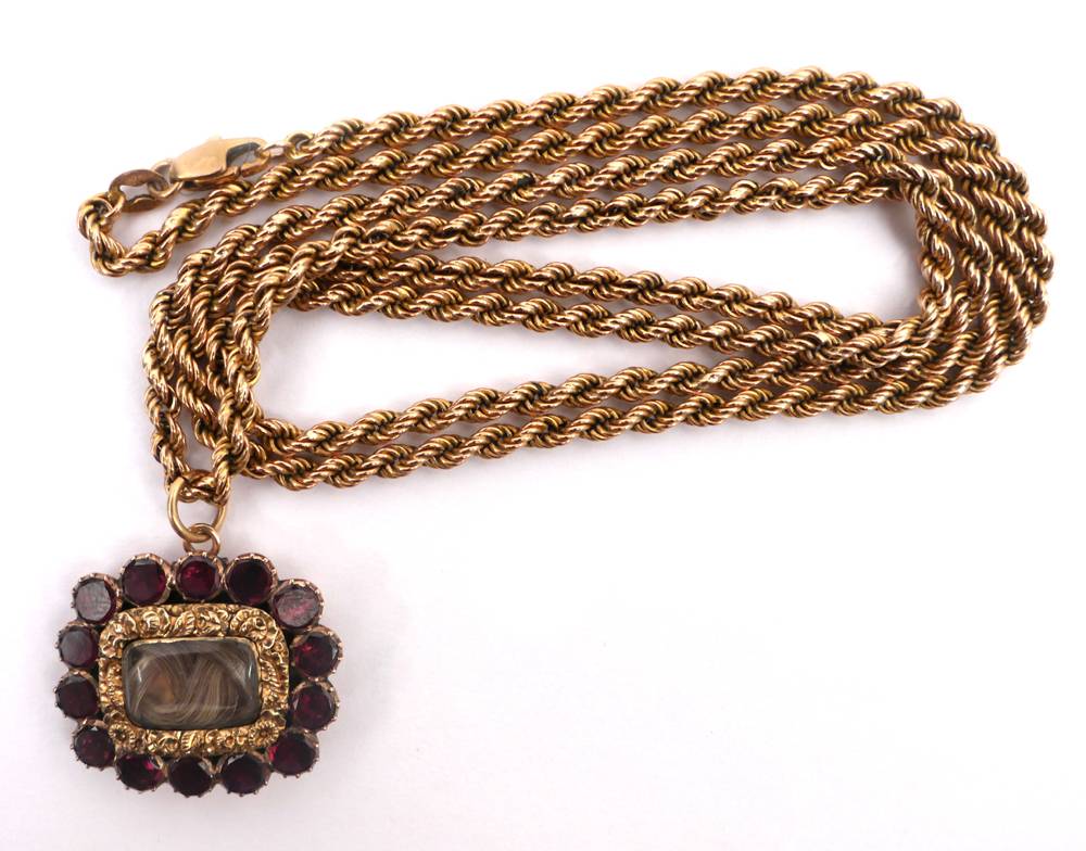 George IV garnet set gilt mourning brooch on 9ct gold chain. at Whyte's Auctions