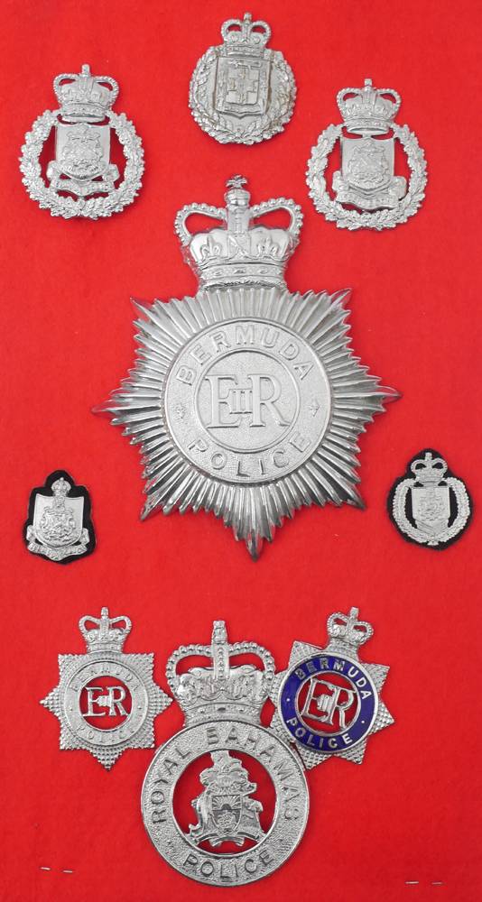 Royal Ulster Constabulary Chief Superintendent's uniform cap and a collection of police helmet plates and badges. at Whyte's Auctions