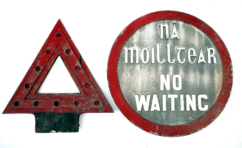 Bilingual Irish-English sign, 'Na Moilltear - No Waiting', and a pole mounted warning triangle. at Whyte's Auctions
