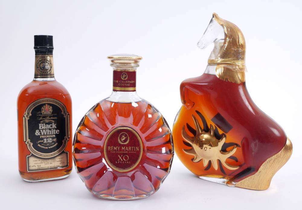 Remy Martin XO Special cognac, Rouyer Guillet Cheval Soleil cognac, and Black and White Premium 12 Year Old Scotch, one bottle each. at Whyte's Auctions