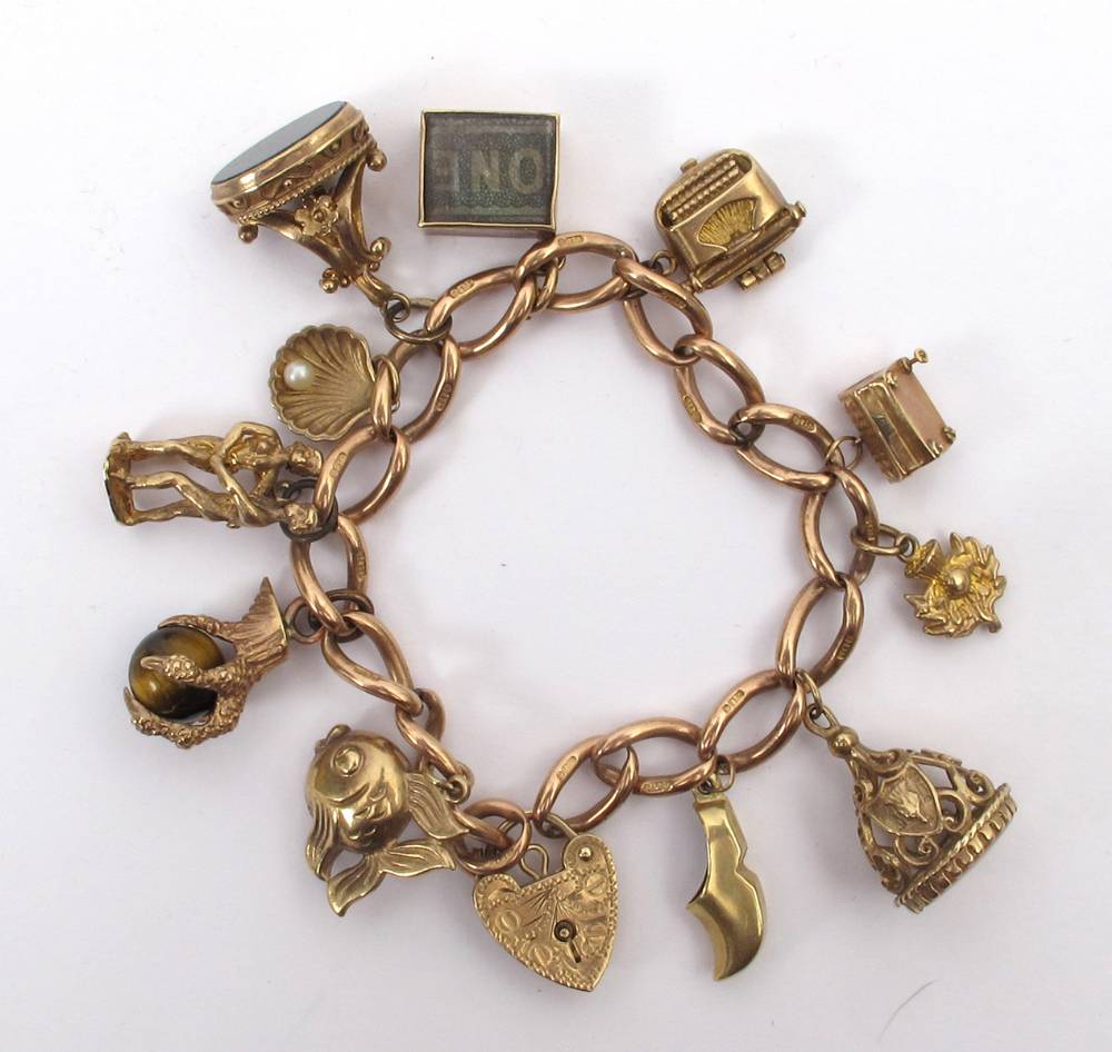 Gold charm bracelet. at Whyte's Auctions