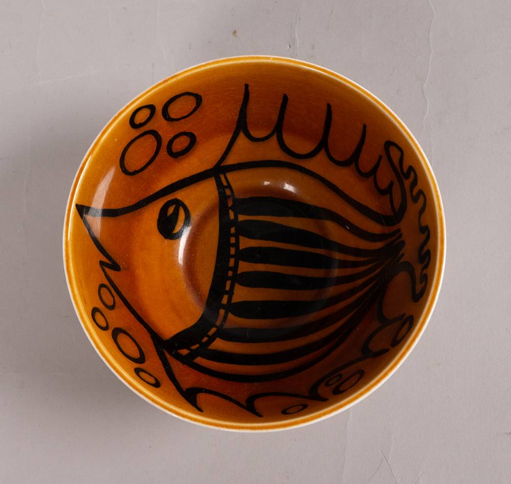BLACK AND AMBER BOWL WITH FISH DESIGN, 1962-64 by John ffrench sold for �540 at Whyte's Auctions